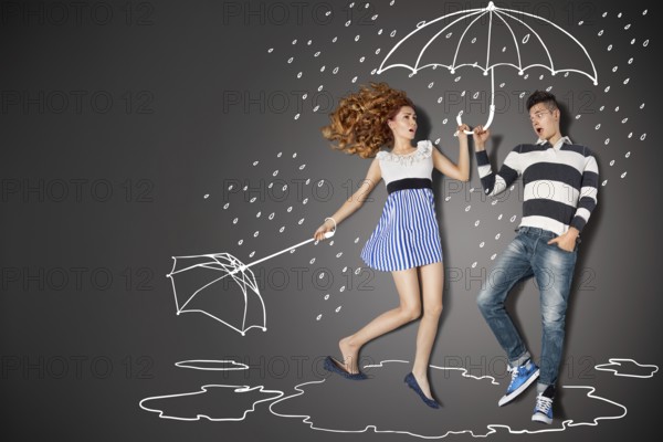 Happy valentines love story concept of a romantic couple in the rain against chalk drawings background