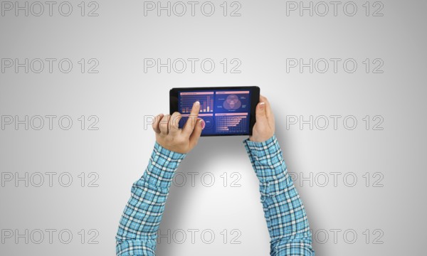 Top view of girl hands using tablet pc with diagrams and graphs on screen