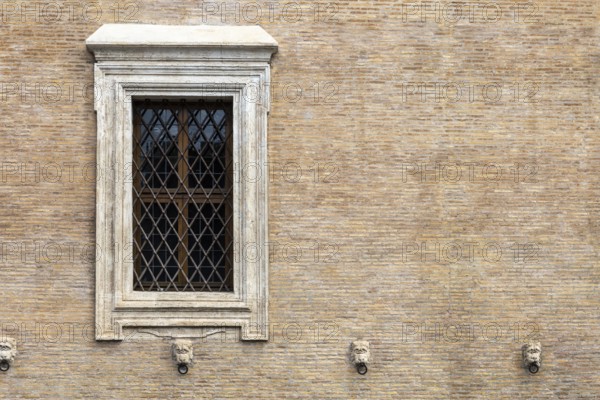 The window with iron gratings on brick wall, for background