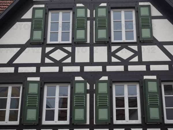 Detailed view of a half-timbered house with green shutters and windows, kandel, pfalz, germany