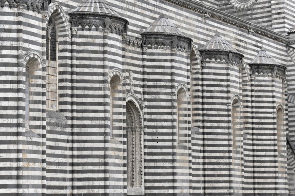 The Cathedral Basilica of Santa Maria Assunta, Orvieto, Terni, Umbria, Italy, Close-up of a striped façade with Gothic windows, Orvieto, Italy, Europe