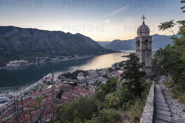 The tower of Church of Our Lady of Remedy and Bay of Kotor view from the hill above the town, Montenegro.