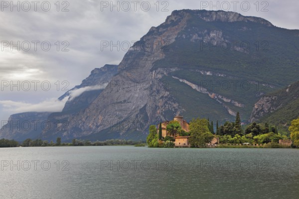 Toblino lake in the mountains of northern Italy and a medieval castle