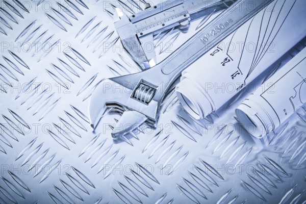 Construction drawings trammel caliper adjustable spanner on grooved metal plate maintenance concept