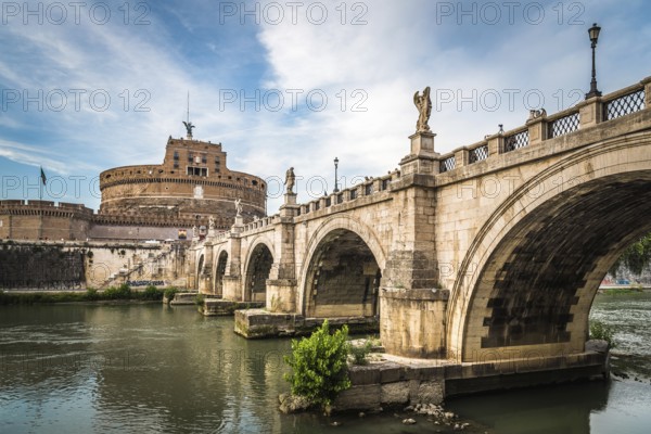 Rome, Italy, August 18, 2016: Bridge and Mausoleum Castel Sant Angelo at sunset. The Mausoleum of Hadrian, usually known as Castel Sant'Angelo is a towering cylindrical building in Rome, Europe