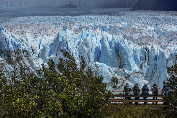 Tourists on wooden plank paths photographing the Perito Moreno glacier, glacier tongue, glacier break, Los Glaciares National Park, Santa Cruz, Patagonia, Argentina, South America