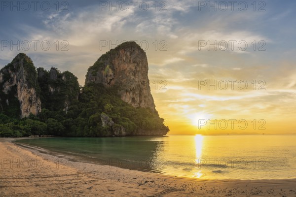 Tropical islands sunset view with ocean sea water and sand beach at Railay Beach, Krabi Thailand nature landscape