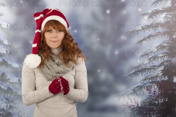 Portrait woman with red Santa Claus hat making snow ball