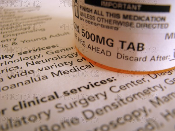 Some prescription medicine on top of some medical documentation