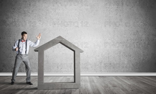 Stone home silhouette in empty room as symbol for real estate insurance