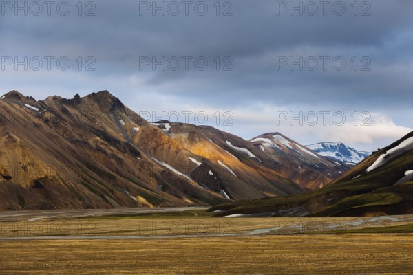 Mountains and hills with blotches of snow in Landmannalaugar, Iceland, Europe