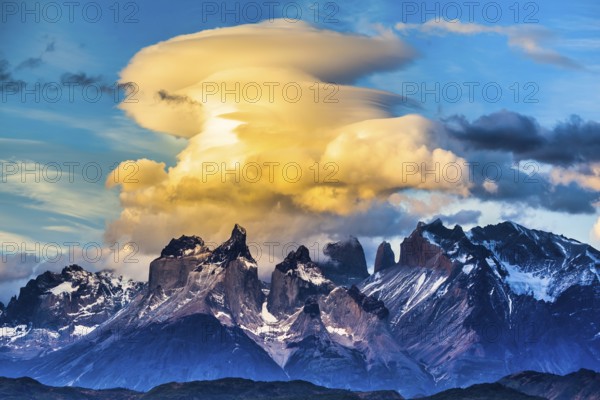 Magnificent cumulus clouds in the rays of the sunset. Torres del Paine National Park. Summer in the south of Chile. The concept of extreme and active tourism
