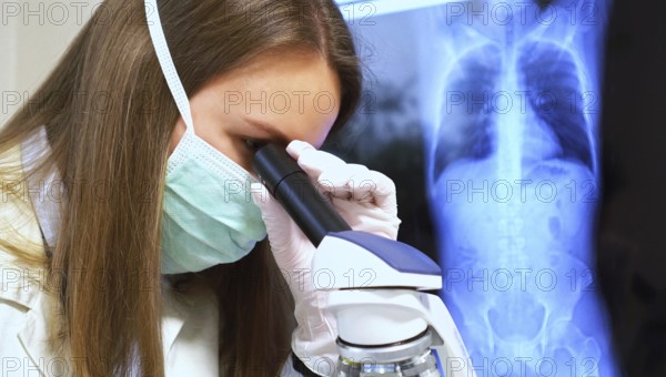 Scientist in medical mask in laboratory. Chest x-ray film on background