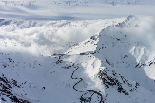 Aerial view of Grossgloknershtrasse in snow. Great high mountain road near Grossglokner mount in Austrian Alps