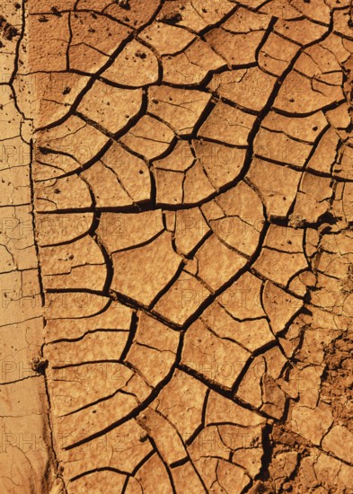 Cracked, dry earth with brown colour tones, reminiscent of arid or desert landscapes. Hiking through Fuerteventura. Canary Islands, Spain, Europe