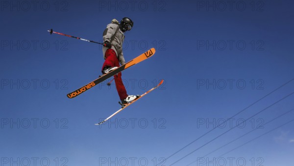 Skier jumping on a snow park in Austrian alps