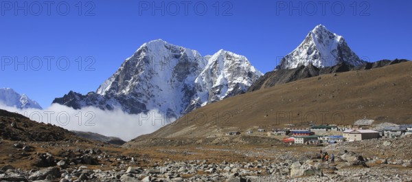 Huts in Lobuche and snow covered mountains Tobuche, Taboche and Cholatse, Nepal, Asia