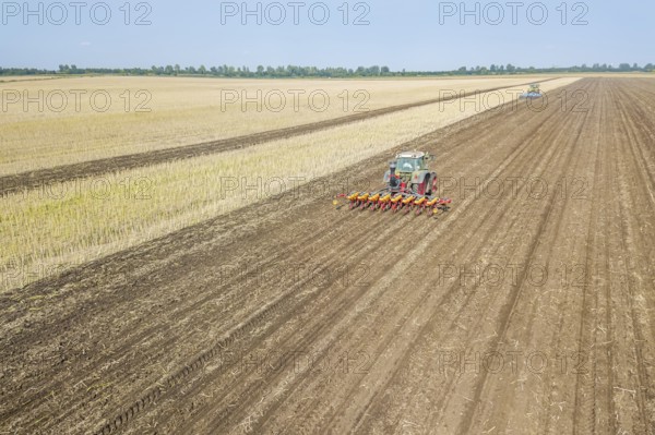 Farmer seeding crops at field. Seeding Aerial View