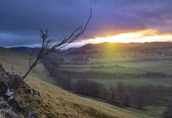 A Beam Of Light From A Winter Sunset Illuminating The Gentle Landscape Of An Agricultural Valley In The Scottish Borders, With Atmospheric Soft Focus