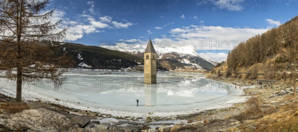 Panorama shot of flooded church tower in Lake Reschen (Reschensee) in South Tyrol, Italy, Europe