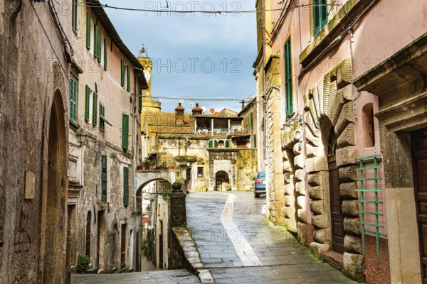 Narrow streets of the picturesque tuff town of Sorano. Etruscan towns of Tuscany. Fairy-tale stone fortress on top of a wooded hill. Towns that have existed for the second millennium. The tuff city of Sorano. Tuscany, Italy. A small town from the Etruscan triangle - the ancient part of the Tuscan hills. The fortress of Sorano