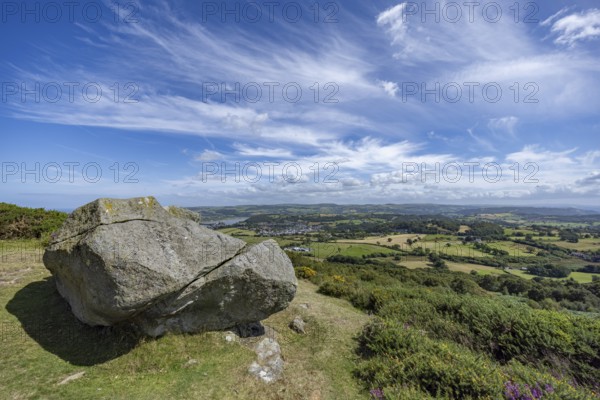 Large rock on a hill with sweeping views over a green landscape around Conwy and Conwy Castle on the edge of Snowdonia National Park, Conwy, Dwygyfylchi, Caernarfonshire, Conwy County Borough, Wales, United Kingdom, Europe