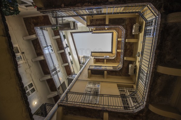 View upwards, inner courtyard of a block of houses. Typical of this type of building in the historic city of Budapest, Hungary, Europe