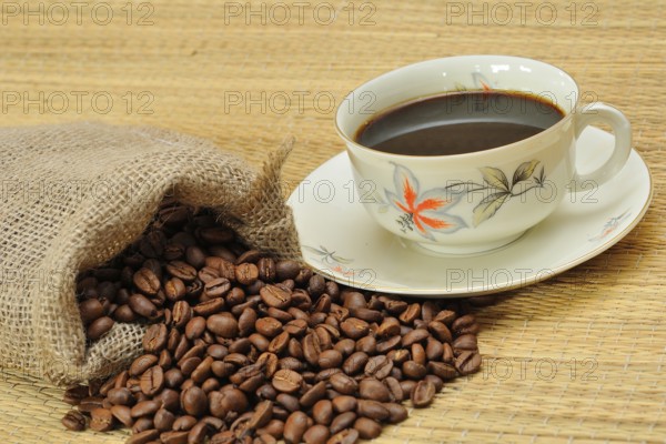Coffee beans next to a coffee cup. Freshly ground coffee, Coffee beans next a coffee cup. Freshly ground coffee to