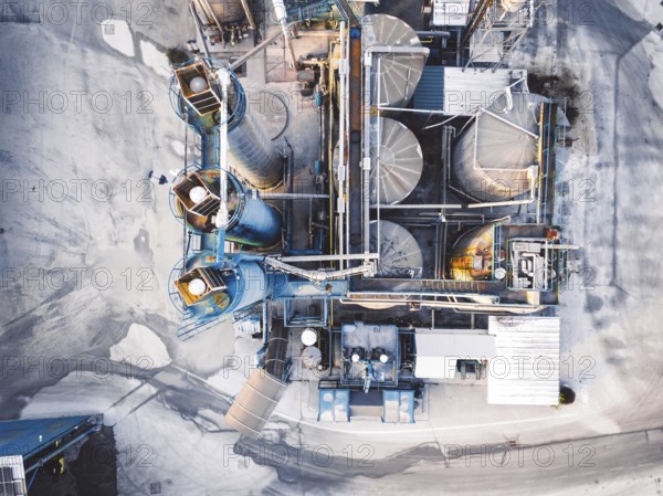 Aerial view of construction firm, asphalt base, whre gravel is being stored for the needs of road repair and other construction highway work