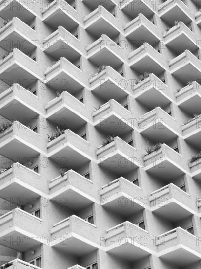High rise building with residential flats or apartments in a white concrete development with balconies
