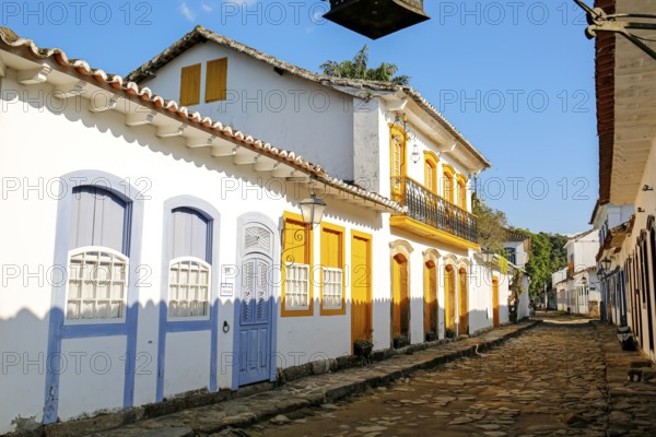 Typical colonial two and one story houses with colorful doors and windows on sunny day in historic town Paraty, Brazil, Unesco World Heritage, South America