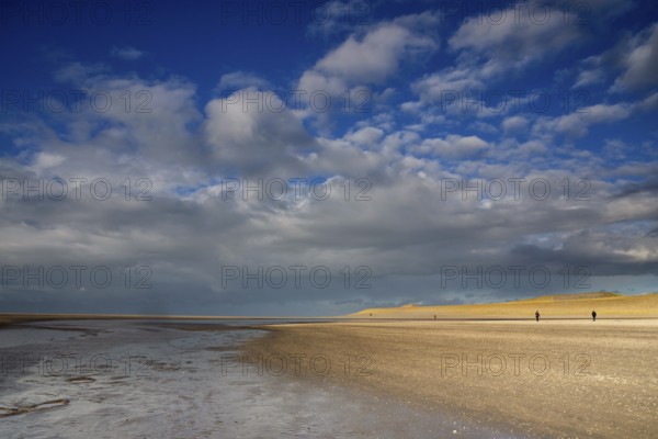 Two people making a beachwalk on the Maasvlaktestrand. This beach is a result of the creation of Maasvlakte 2. Maasvlakte 2 is the latest expansion of the Rotterdam harbour