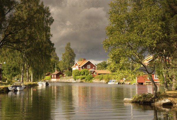 Dark sky over the Sundbornan river in the Swedish village Sundborn in the province Dalarna