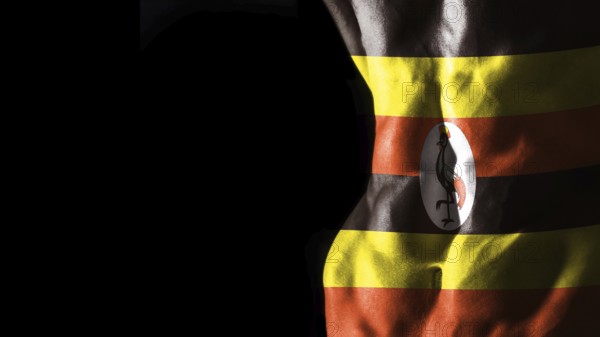 Uganda flag on abs muscles national sport workout, bodybuilding concept, black background
