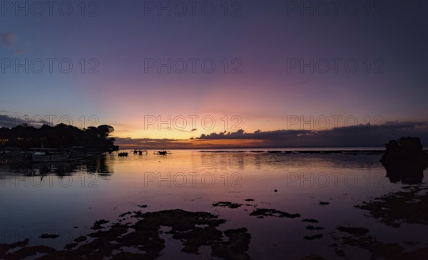 Sunset at Mushroom Beach with boats on the sea, Lembongan, Bali, Indonesia, Asia