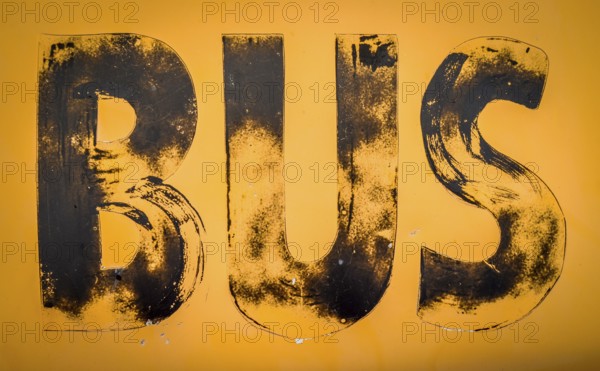 Aged Old Worn And Weathered Yellow Sign For A Bus