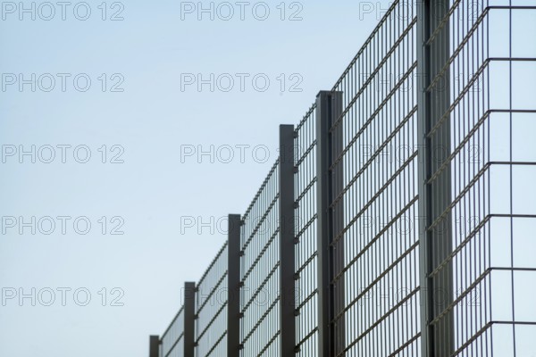 Large metal fence with sky