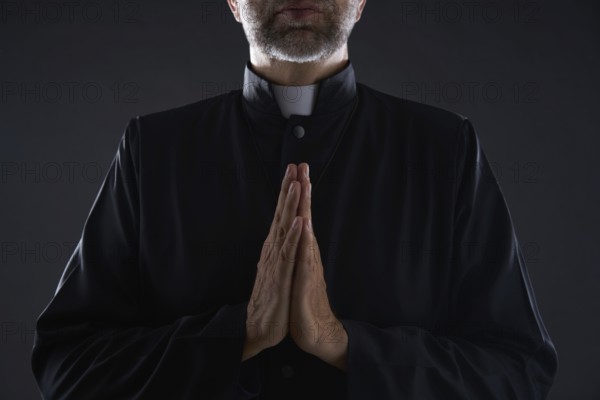 Praying hands priest portrait of male pastor