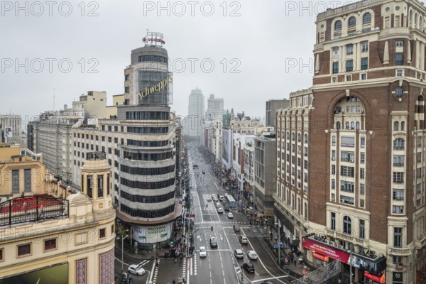 Madrid, Spain, November 20, 2016: Rainy day in Gran Via in Madrid. It is an ornate and upscale shopping street located in central Madrid. It is known as the Spanish Broadway. High angle view, Europe