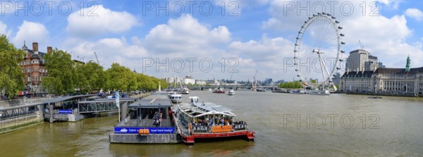 Panorama of Westminster Millennium Pier on the north bank of the River Thames with London Eye at background in London, United Kingdom, Europe