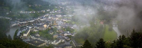 Bouillon, Belgium, 04th of August 2023: High angle viewpoint on the city of Bouillon in the Ardennes, Wallonia, Belgium. Rainy and cloudy day covering the city in fog, Europe