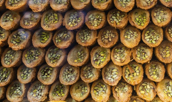 Turkish traditional dessert Kadayif baked in syrup served with nut powder