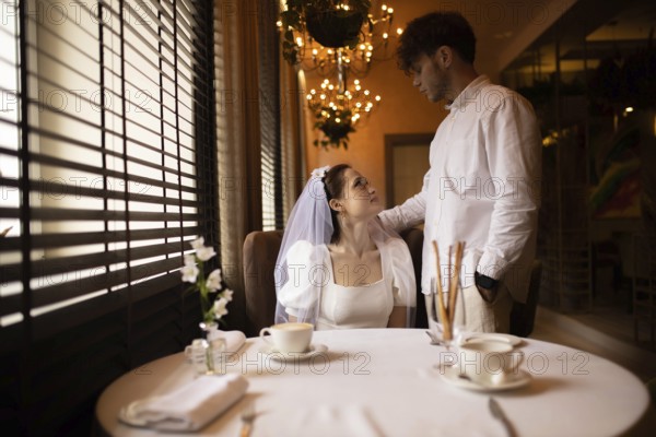 Bride and groom casually standing in a cafe with a relaxed atmosphere