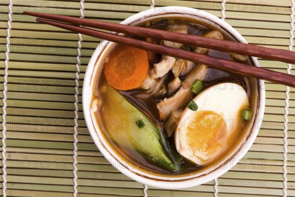 Ramen egg noodle soup dish with salmon fish