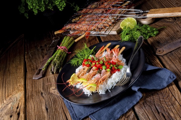 Grilled red argentine shrimps with red salsa and green asparagus