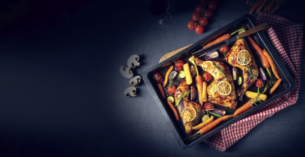Grilled chicken legs with various vegetables and herbs
