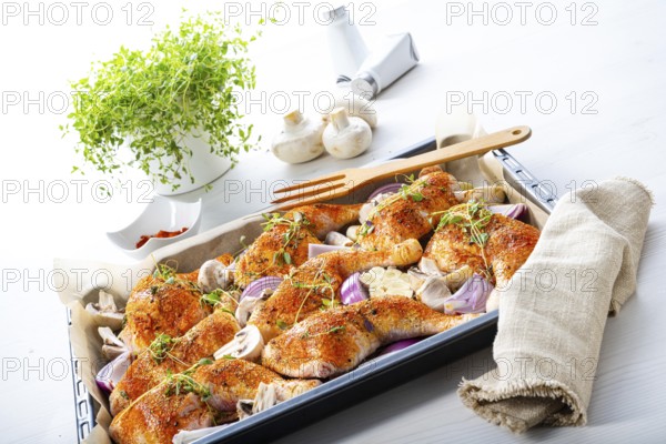 Prepared chicken legs with various vegetables and herbs