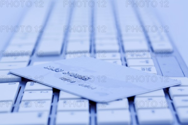 Close-up of a credit card for cashless payment and keyboard. Symbol photo for shopping on the Internet. Austria