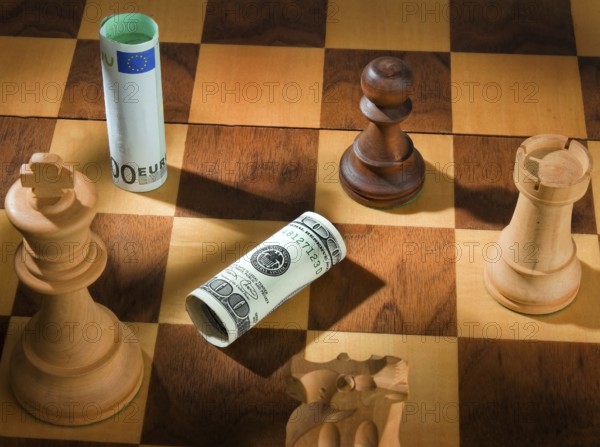 Chess with dollar and euro banknote. Symbol for devaluation of the dollar against the euro. Austria
