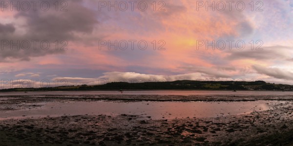 A panorama view of the Clyde River near Dumbarton at low tide at sunset